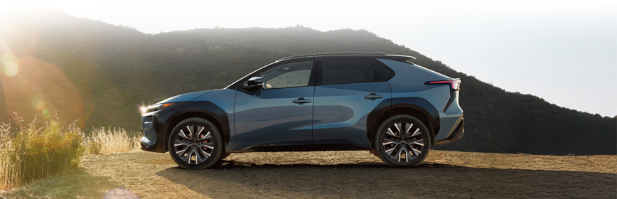 Rear shot of 2026 Solterra driving on dirt road.